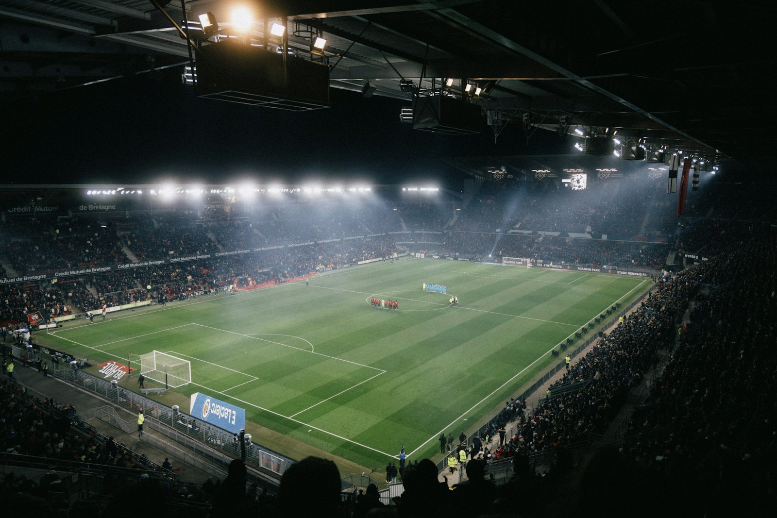 A stadium pitch under floodlights at night